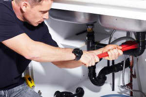 Biard and Crockett plumber fixing a sink in Tustin, CA
